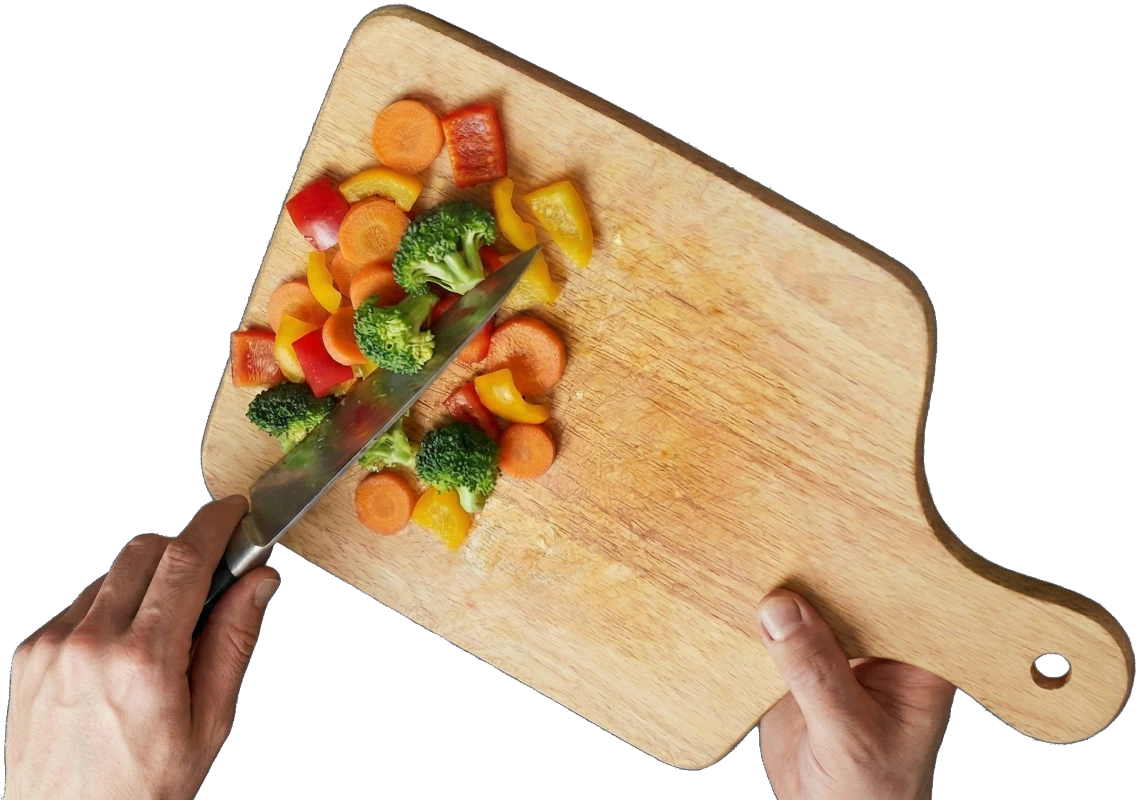 Hands chopping vegetables on cutting board